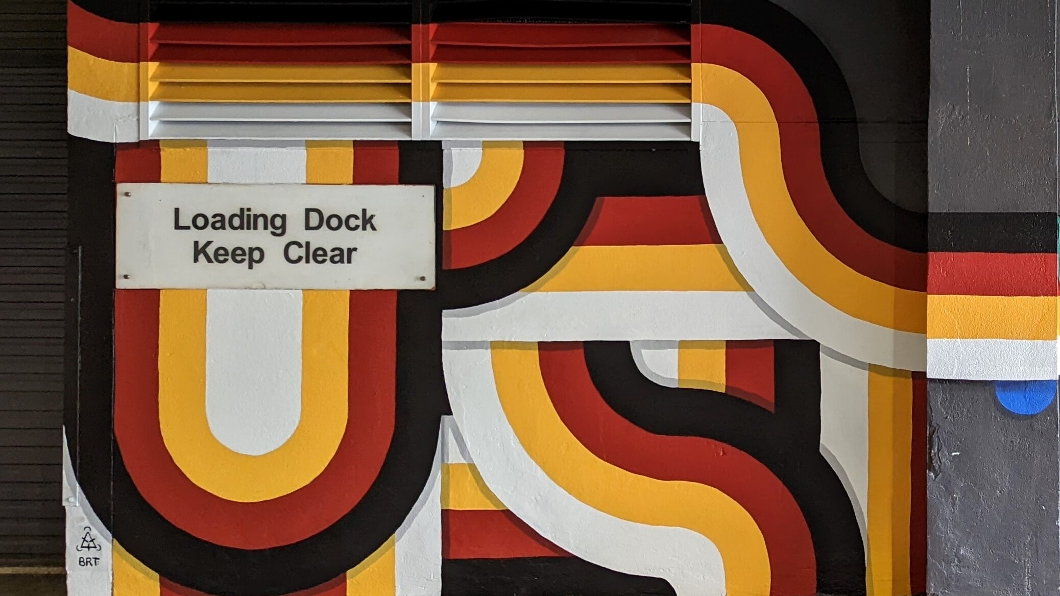 Red, black, yellow and white geometric mural