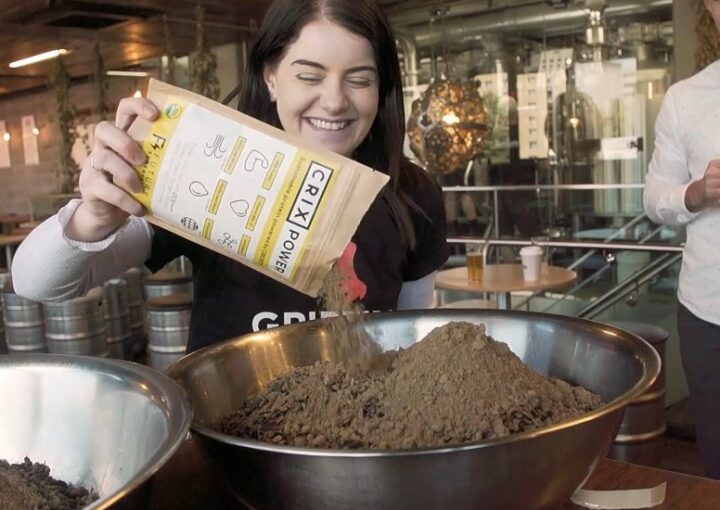 Girl adds ingredients to a bowl for beer brew