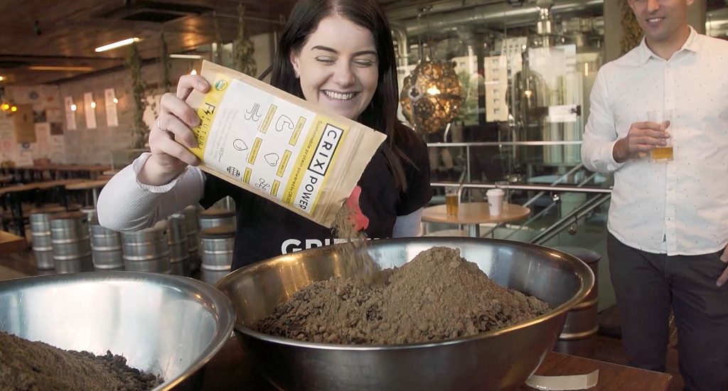 Girl adds ingredients to a bowl for beer brew