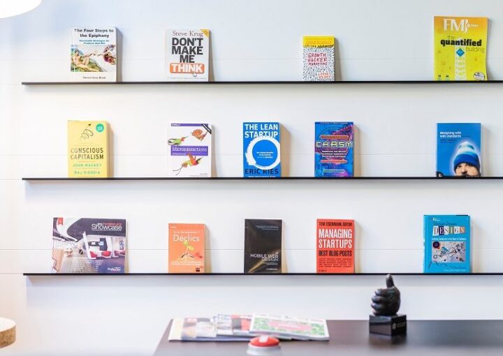 Startup books displayed on a wall