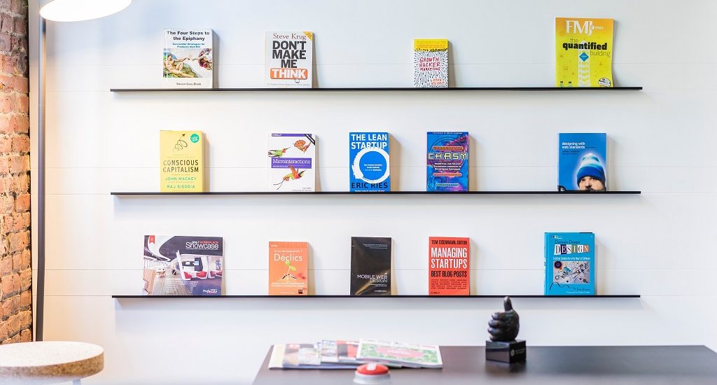 Startup books displayed on a wall